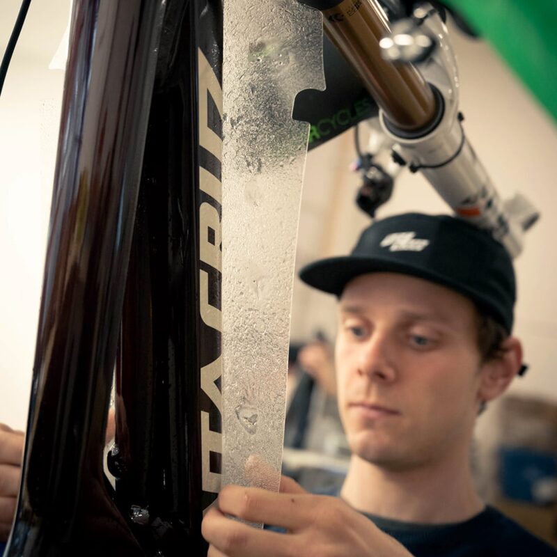DT-application RideWrap protection kit being applied to bike frame.