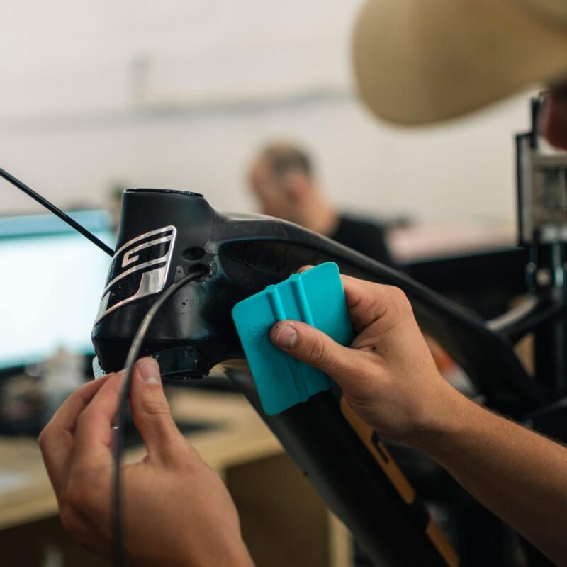 Force RideWrap protection kit being applied to bike frame.